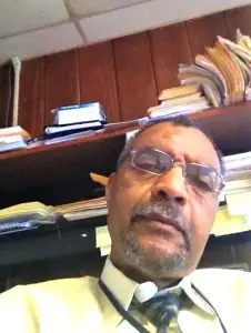 Staff member headshot at a desk in Writers House
