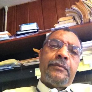 Staff member headshot at a desk in Writers House